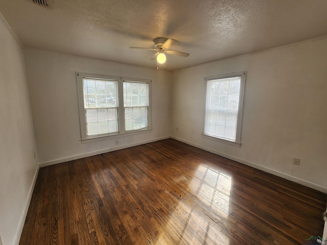 unfurnished room with ceiling fan, dark wood-type flooring, and a textured ceiling