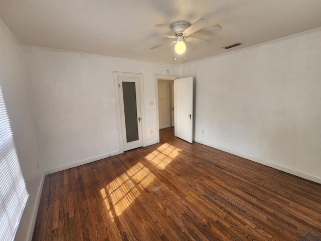 spare room featuring ceiling fan, dark hardwood / wood-style flooring, and ornamental molding