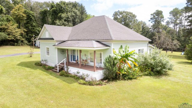 exterior space with a lawn and a porch