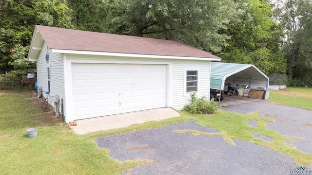 garage with a yard and a carport