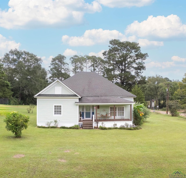 view of front facade with covered porch and a front yard