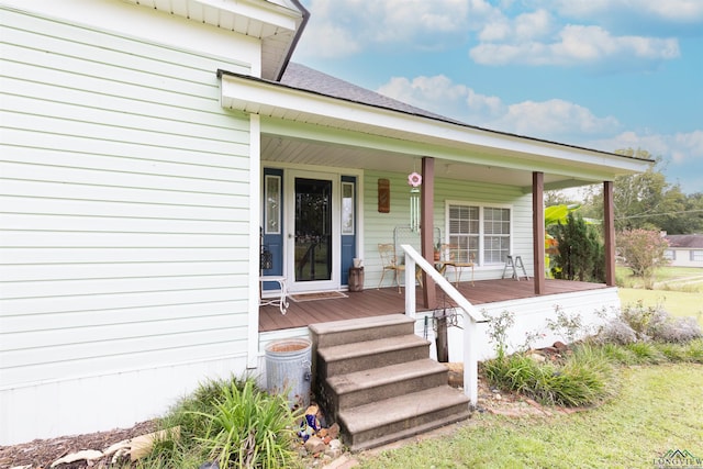 view of exterior entry featuring covered porch