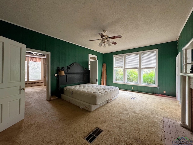 unfurnished bedroom with ceiling fan, carpet, and a textured ceiling