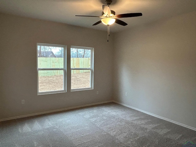 unfurnished room featuring ceiling fan and carpet