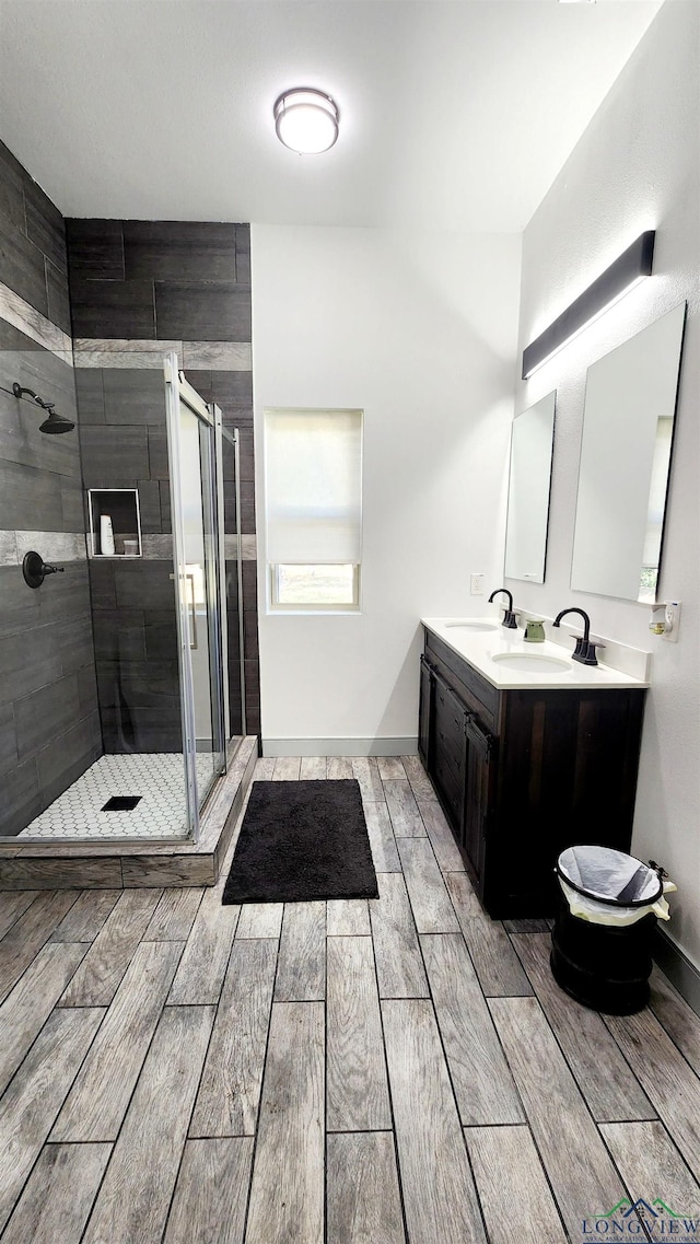 bathroom featuring vanity and an enclosed shower