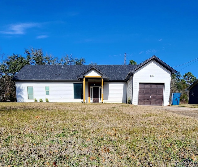 ranch-style house with a garage and a front yard