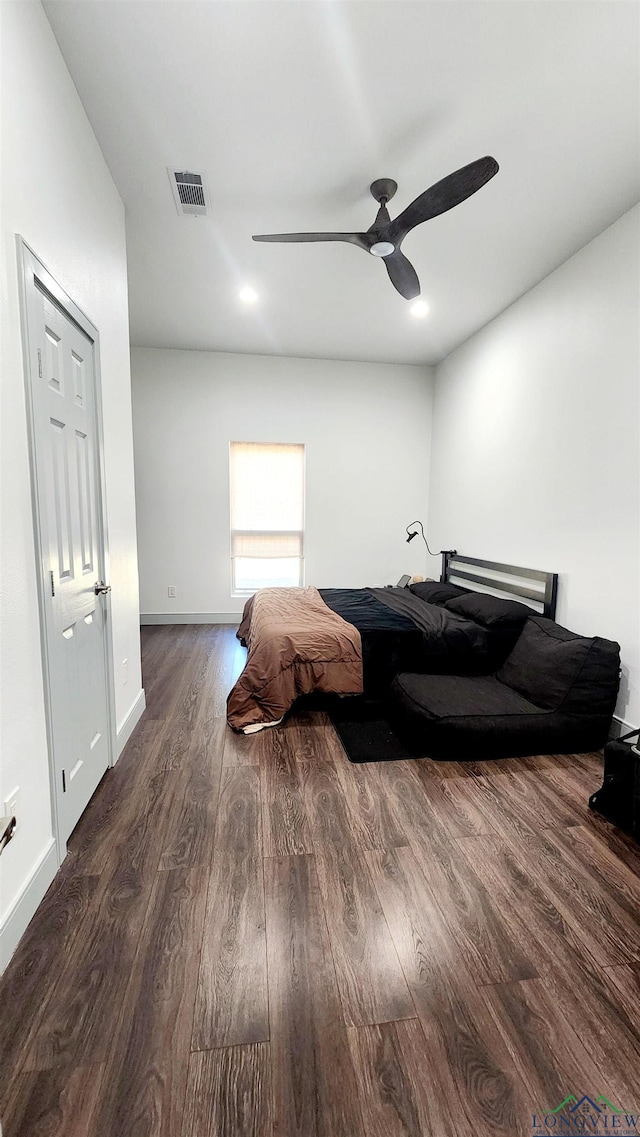 bedroom with ceiling fan and dark hardwood / wood-style flooring