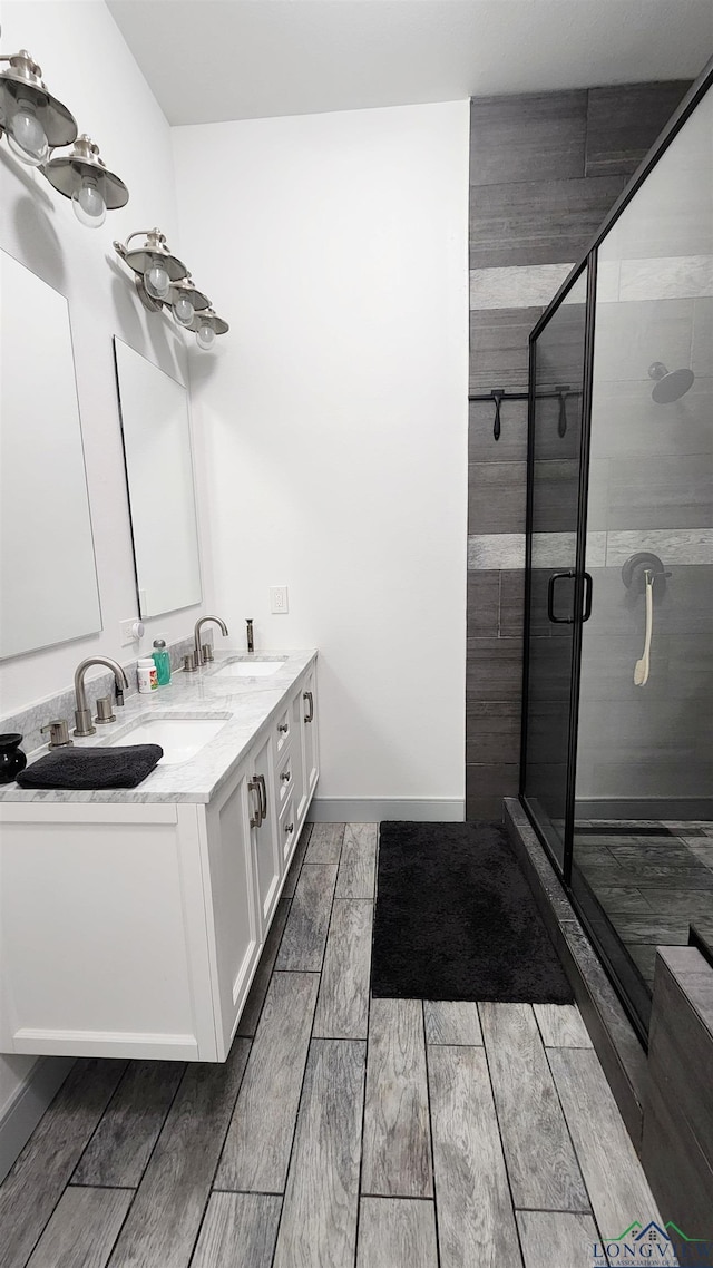 bathroom with vanity and a shower with shower door