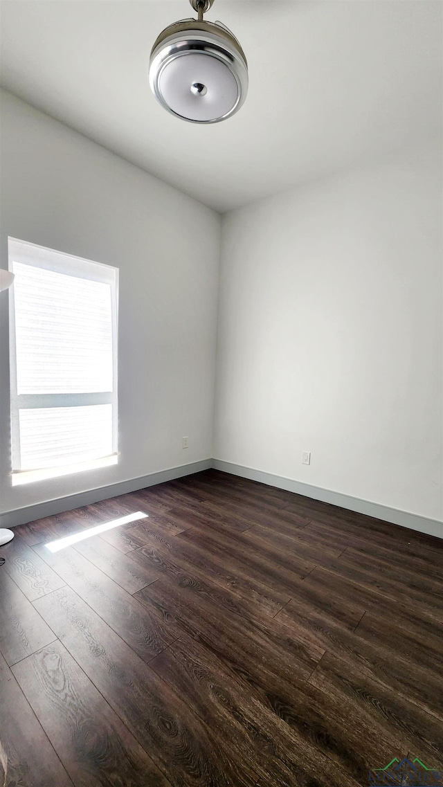 empty room featuring dark wood-type flooring