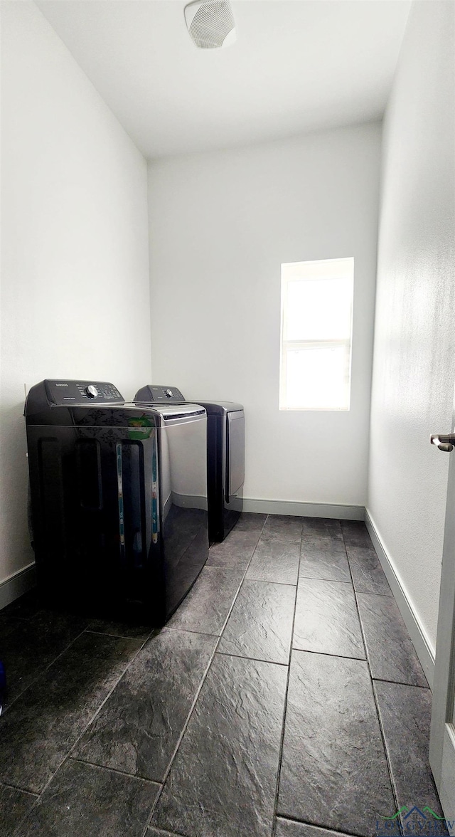 clothes washing area featuring separate washer and dryer