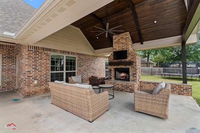 224 Stonegate Dr, Carthage, TX 75633 - view of patio featuring a trampoline, a ceiling fan, and an outdoor living space with a fireplace