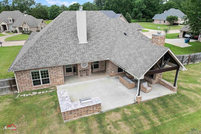 224 Stonegate Dr, Carthage, TX 75633 - back of property with a chimney, roof with shingles, and a patio area