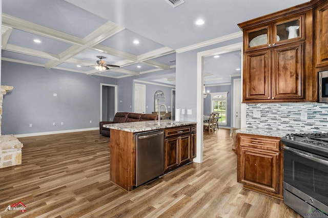 224 Stonegate Dr, Carthage, TX 75633 - kitchen with stainless steel appliances, light wood finished floors, a ceiling fan, light stone counters, and beamed ceiling