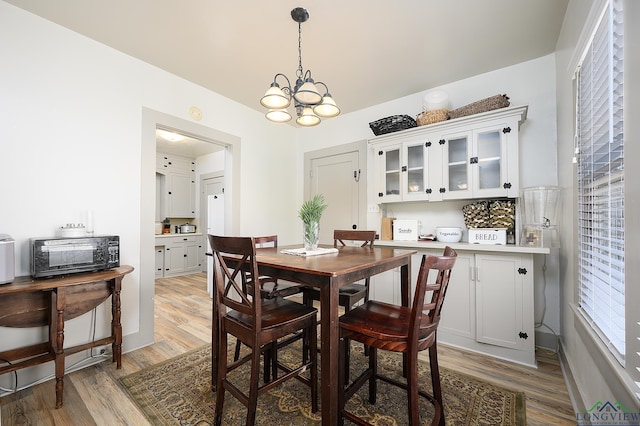 dining room featuring hardwood / wood-style floors and a chandelier