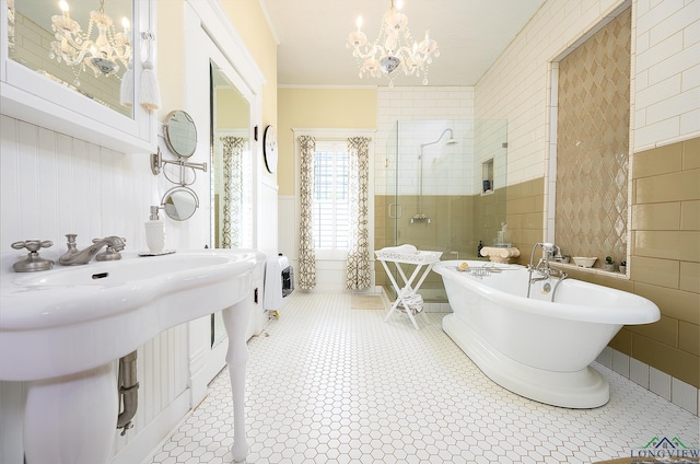 bathroom with a notable chandelier, tile patterned floors, heating unit, shower with separate bathtub, and ornamental molding