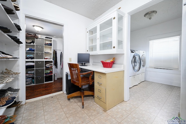 office featuring separate washer and dryer and a textured ceiling