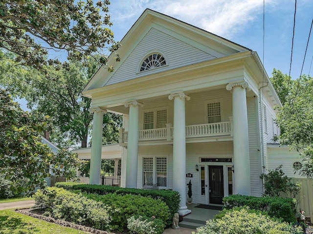 greek revival house featuring a balcony