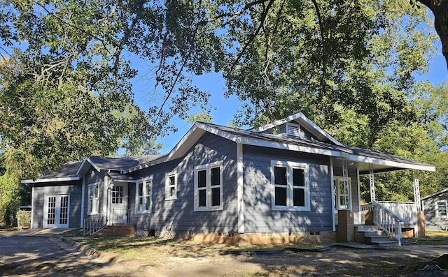 view of side of home featuring french doors