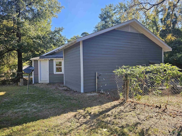 view of side of home with a lawn