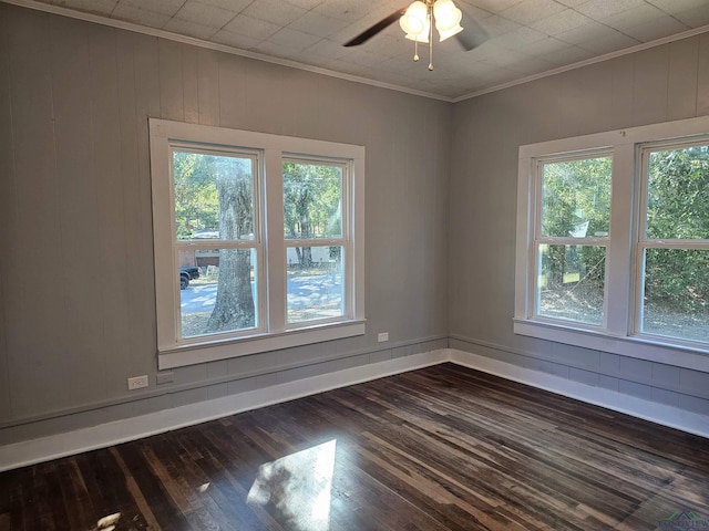 unfurnished room featuring dark hardwood / wood-style flooring, a healthy amount of sunlight, and ornamental molding