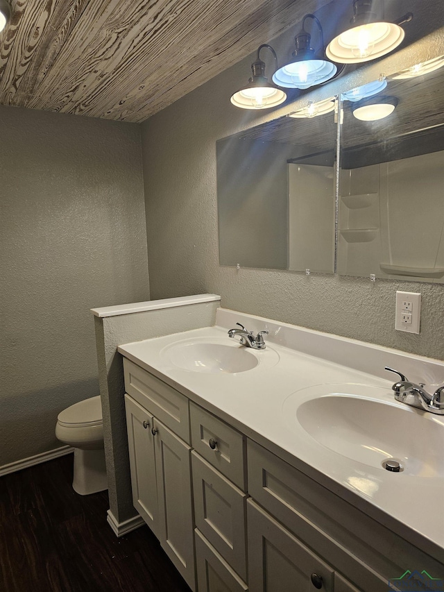 bathroom with hardwood / wood-style flooring, vanity, toilet, and wooden ceiling