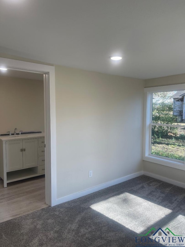 carpeted spare room with sink