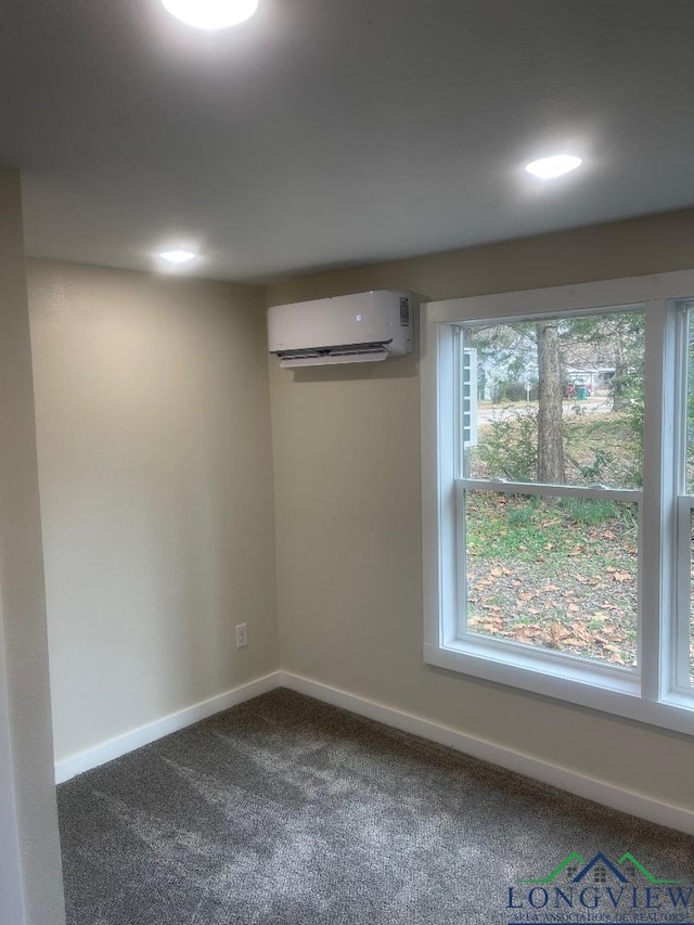 carpeted empty room featuring an AC wall unit