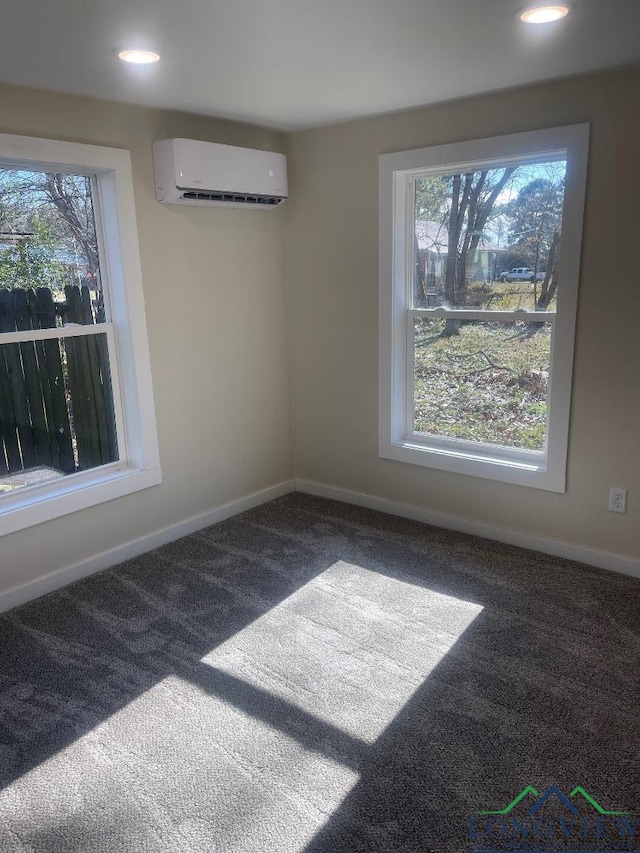 interior space featuring carpet floors, plenty of natural light, and an AC wall unit