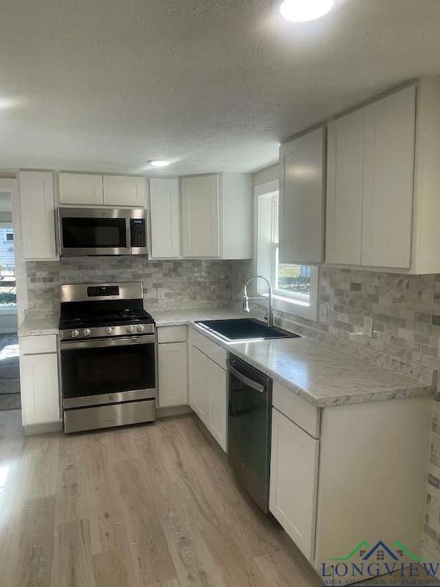 kitchen featuring white cabinetry and appliances with stainless steel finishes