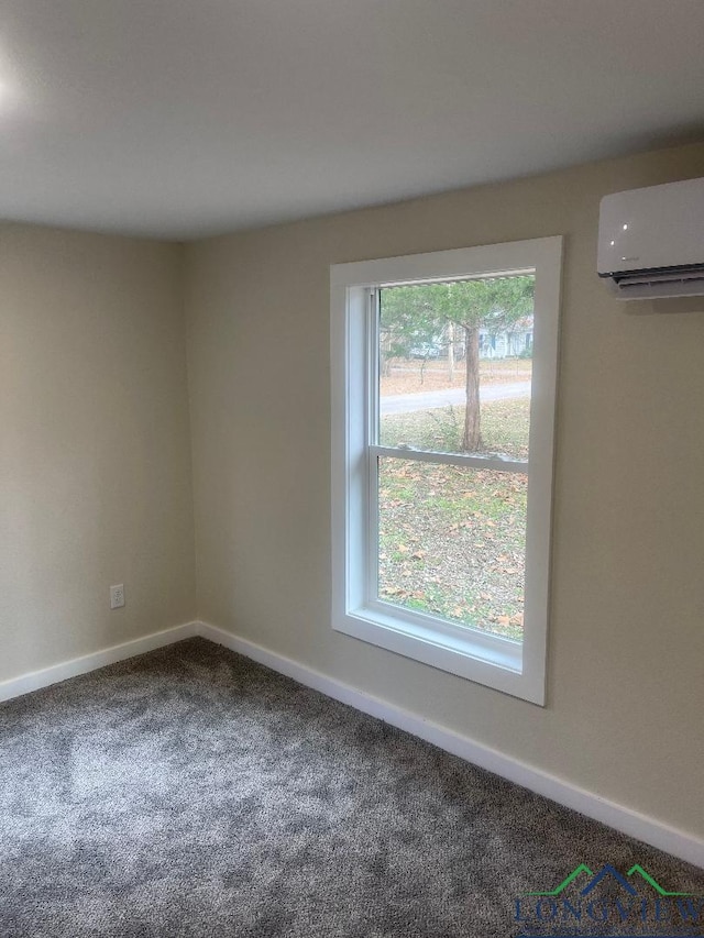 empty room with a wall mounted air conditioner and carpet