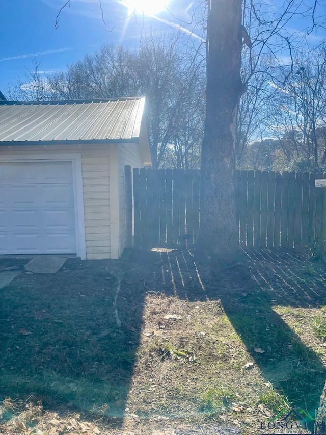 view of side of property with a garage and an outdoor structure