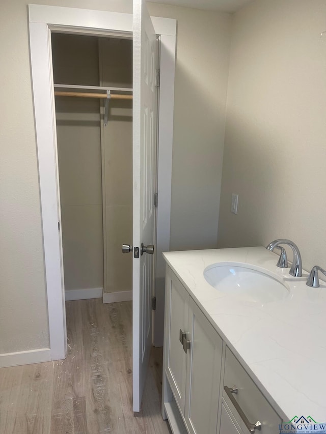 bathroom featuring wood-type flooring and vanity