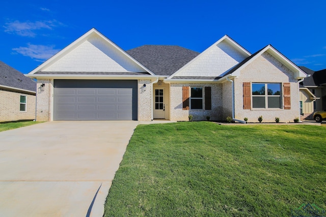 view of front of property featuring a garage and a front lawn