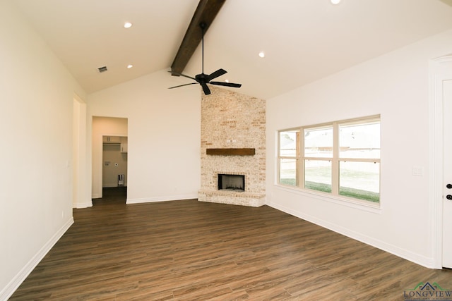 unfurnished living room with beam ceiling, ceiling fan, dark wood-type flooring, high vaulted ceiling, and a fireplace