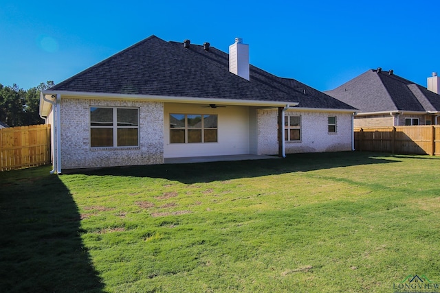 rear view of house with a patio area and a yard