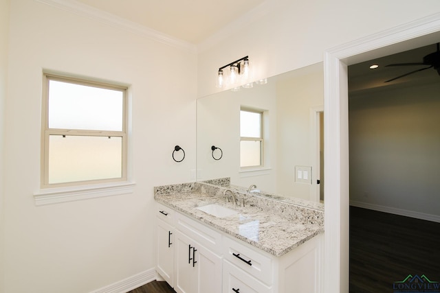 bathroom with crown molding, vanity, wood-type flooring, and ceiling fan