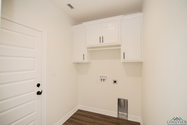 laundry area with hookup for a washing machine, cabinets, dark hardwood / wood-style floors, and hookup for an electric dryer