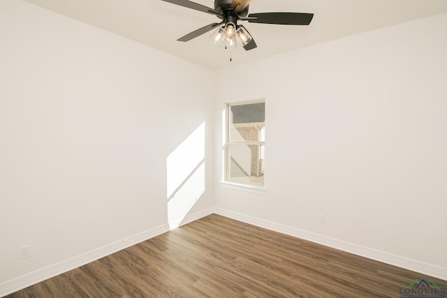 empty room with ceiling fan and dark hardwood / wood-style flooring