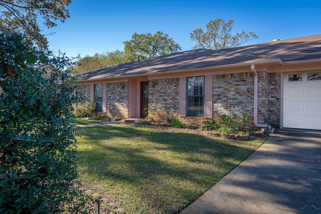 ranch-style home with a front lawn and a garage