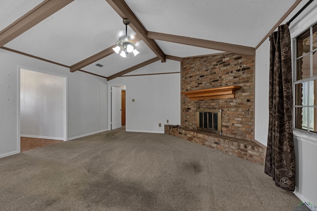 unfurnished living room featuring carpet flooring, lofted ceiling with beams, a textured ceiling, and a brick fireplace