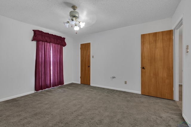 carpeted spare room with a textured ceiling