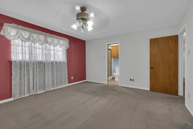 carpeted empty room featuring a textured ceiling and ceiling fan