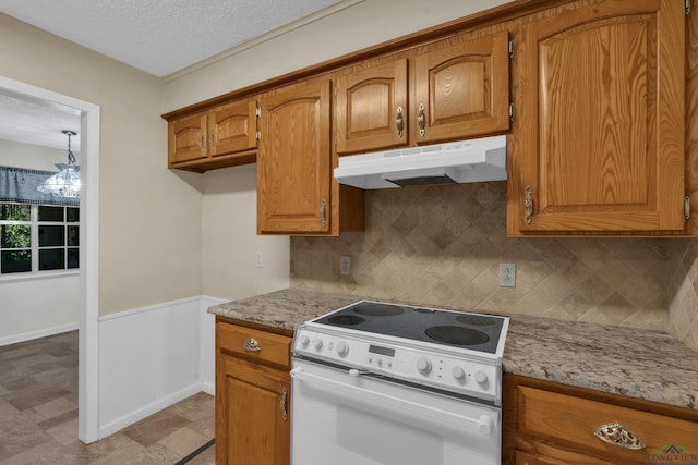 kitchen featuring decorative backsplash, light stone counters, white electric range, and a textured ceiling