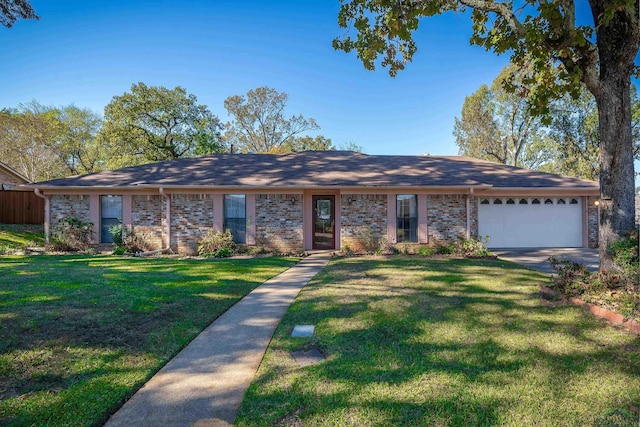 single story home featuring a garage and a front lawn