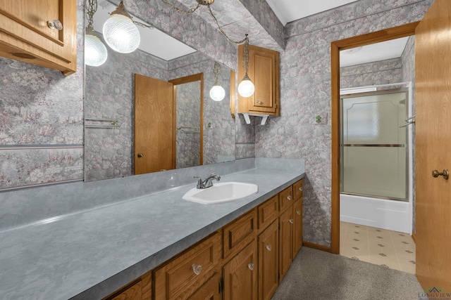 bathroom with vanity and bath / shower combo with glass door