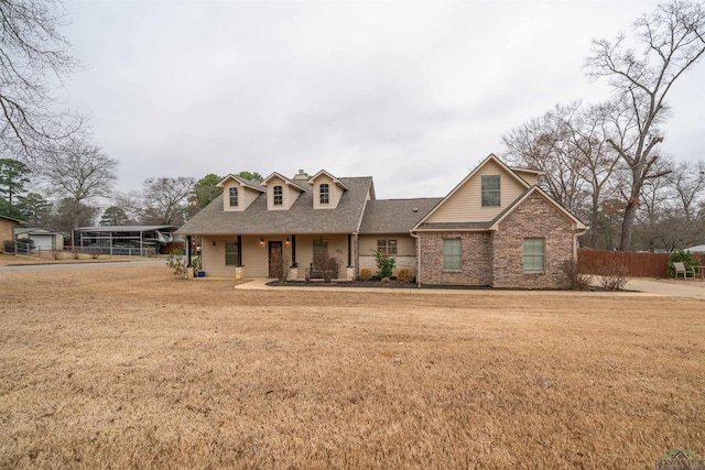 view of front of house with a carport and a front lawn