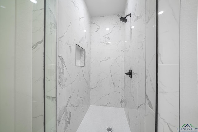 bathroom with a tile shower