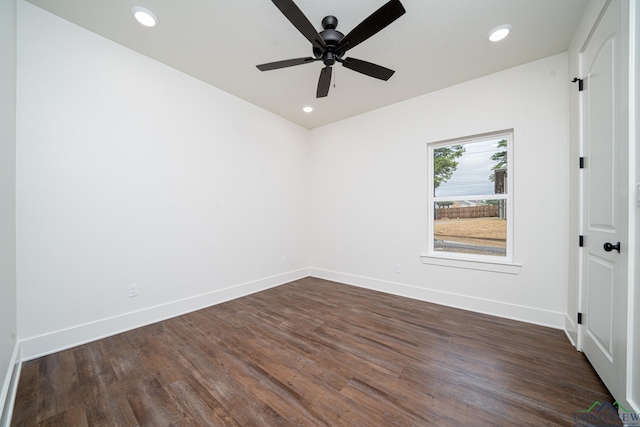 empty room with ceiling fan and dark hardwood / wood-style flooring