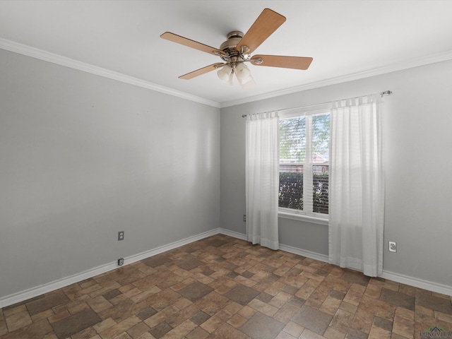spare room featuring stone finish floors, crown molding, baseboards, and ceiling fan