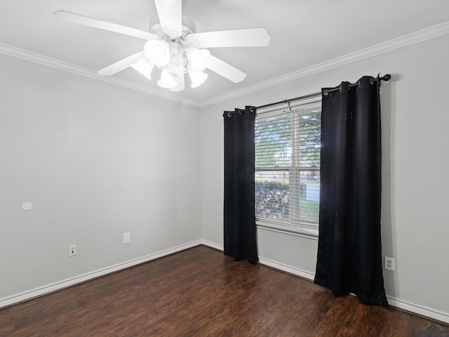 spare room featuring wood finished floors, ornamental molding, ceiling fan, and baseboards